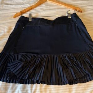 TAIL women’s pleated active golf skirt with built-in shorts